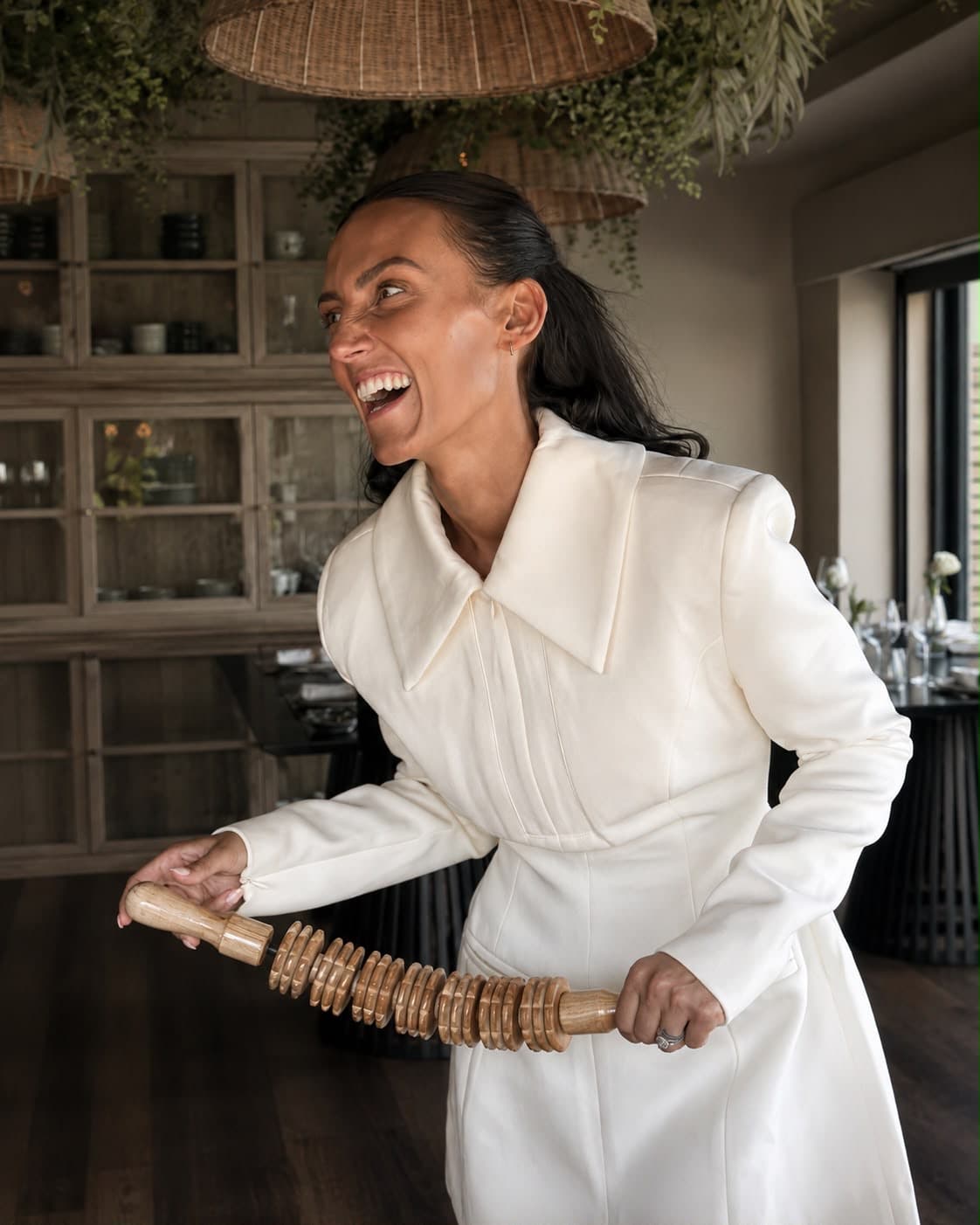 Amelia holding a professional wood-therapy roller