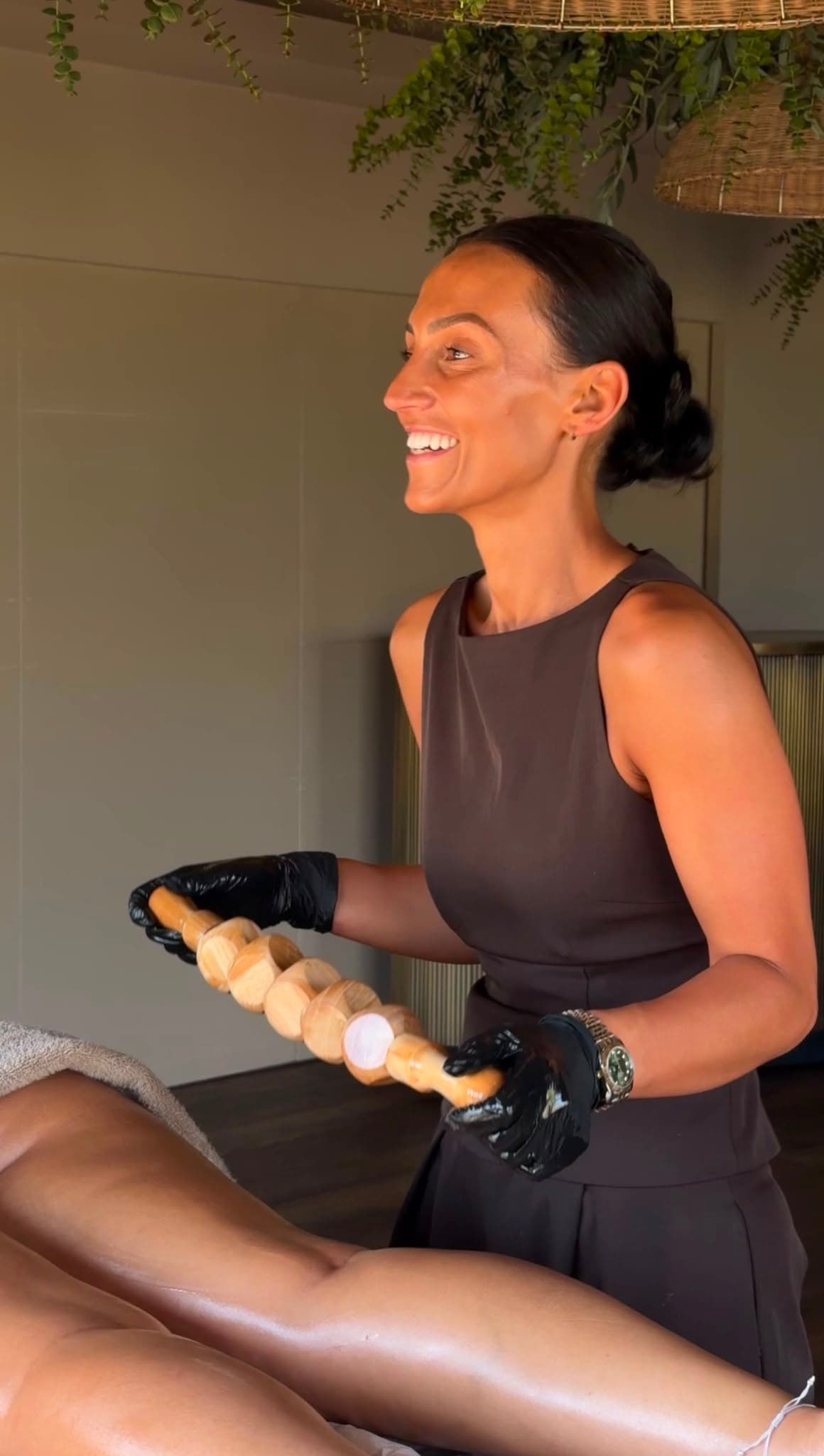 Amelia performing a wood-therapy treatment in her studio